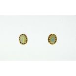 A pair of 9ct yellow gold oval opal ear studs, the opals with ropework borders. THIS LOT WILL BE