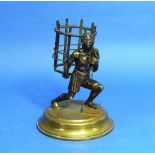 A 19thC French gilt bronze figure of a Negro, carrying a basket on his back, on circular base, 5¾