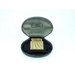 A 9ct gold Colibri Monopol cigarette lighter, of canted rectangular form with engine-turned