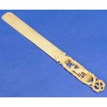 A 19thC ivory Letter Knife / Page Turner, the handle carved with a dog seated within entwined tree