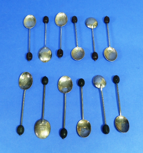 A set of six silver Coffee Bean spoons, hallmarked Birmingham, 1956, with shell chased bowls, cased,