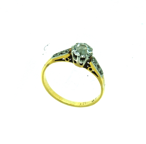 A single stone diamond Ring, with three small diamond points on each shoulder, the centre stone c.½