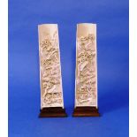 A pair of late 19thC Chinese ivory Wrist Rests, the interiors deeply carved with mountainous