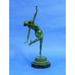 An Art Deco green patinated bronze figure of a Nude, signed 'T. Carrier', she standing on one leg,