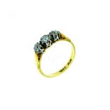 A Ring set with three small diamonds, mounted in 18ct yellow gold and platinum, Size K. THIS LOT