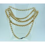 A singe row of cultured Pearls, with paste clasp, 17in (44cm) together with a long row of cultured