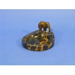 An Art Deco marbled Ashtray, of ovoid form, surmounted by a bronze Elephant, 6in (15cm) wide.