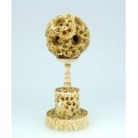 A 19thC Chinese carved ivory Puzzle Ball on Stand, the ball with carved outer layer detailed with