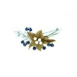 A floral Brooch, in 9ct white gold leaves and stems, with a central yellow gold fine pedaled flower,