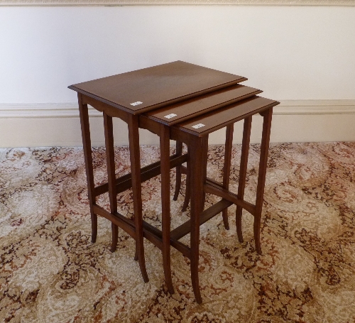 An Edwardian mahogany nest of three Tables, 22in (56cm) wide (3) Provenance: Stoodley Knowle School,