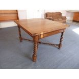 An oak draw-leaf Dining Table, with barley twist legs. Provenance: Stoodley Knowle School, Torquay.