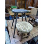 An antique painted oak Milking Stool, together with a mahogany framed overstuffed stool (2)