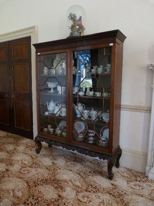 An early 20thC mahogany Bookcase, with astragal glazed doors, 55in (140cm) wide. Provenance: