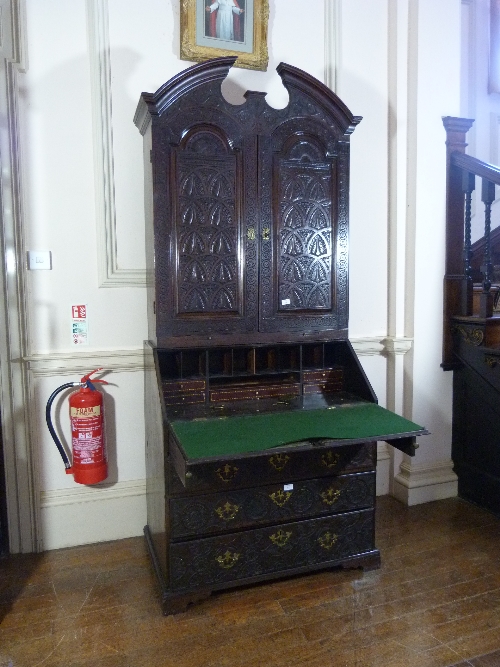 A Victorian carved oak Bureau Cabinet, with fitted interiors, 38½in (98cm) wide. Provenance: