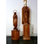 A pair of mid-20thC carved statues of Jesus Christ and the Virgin Mary, highlighted in gilt, each