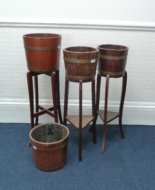 Two brass-bound oak planters-on-stands, another larger, and a plant pot similar (4) Provenance: