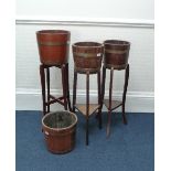 Two brass-bound oak planters-on-stands, another larger, and a plant pot similar (4) Provenance: