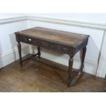 A Victorian carved oak Writing Table, 45in (114cm) wide. Provenance: Stoodley Knowle School,