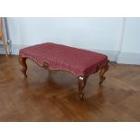 A Victorian walnut Rococo-style Stool, with upholstered seat, 42in (106.5cm) wide. Provenance: