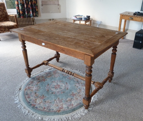 An oak plank-top Table, with turned legs and stretchers, 48in (122cm) wide. Provenance: Stoodley