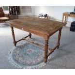 An oak plank-top Table, with turned legs and stretchers, 48in (122cm) wide. Provenance: Stoodley