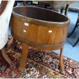 An oak and brass bound oval Planter, formerly a wine cooler.