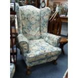 A pair of early 20thC upholstered wing back Arm Chairs, on walnut cabriole legs with claw and ball