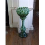 A green glazed pottery Jardinière-on-Stand, moulded decoration, 40in (101.5cm) high. Provenance: