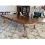 An early 20thC walnut extending Dining Table, with three leaves, 120in (305cm) long. Provenance: