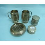 A pair of 20thC Indian silver Mugs, of ovoid form with bands of foliate and geometric decoration,