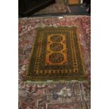 A 'golden' Afghan rug with three elephant foot guls, 140 x 100.