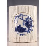 A Chinese faux bamboo porcelain brush pot, two panels of blue glaze flowers and ducks, character