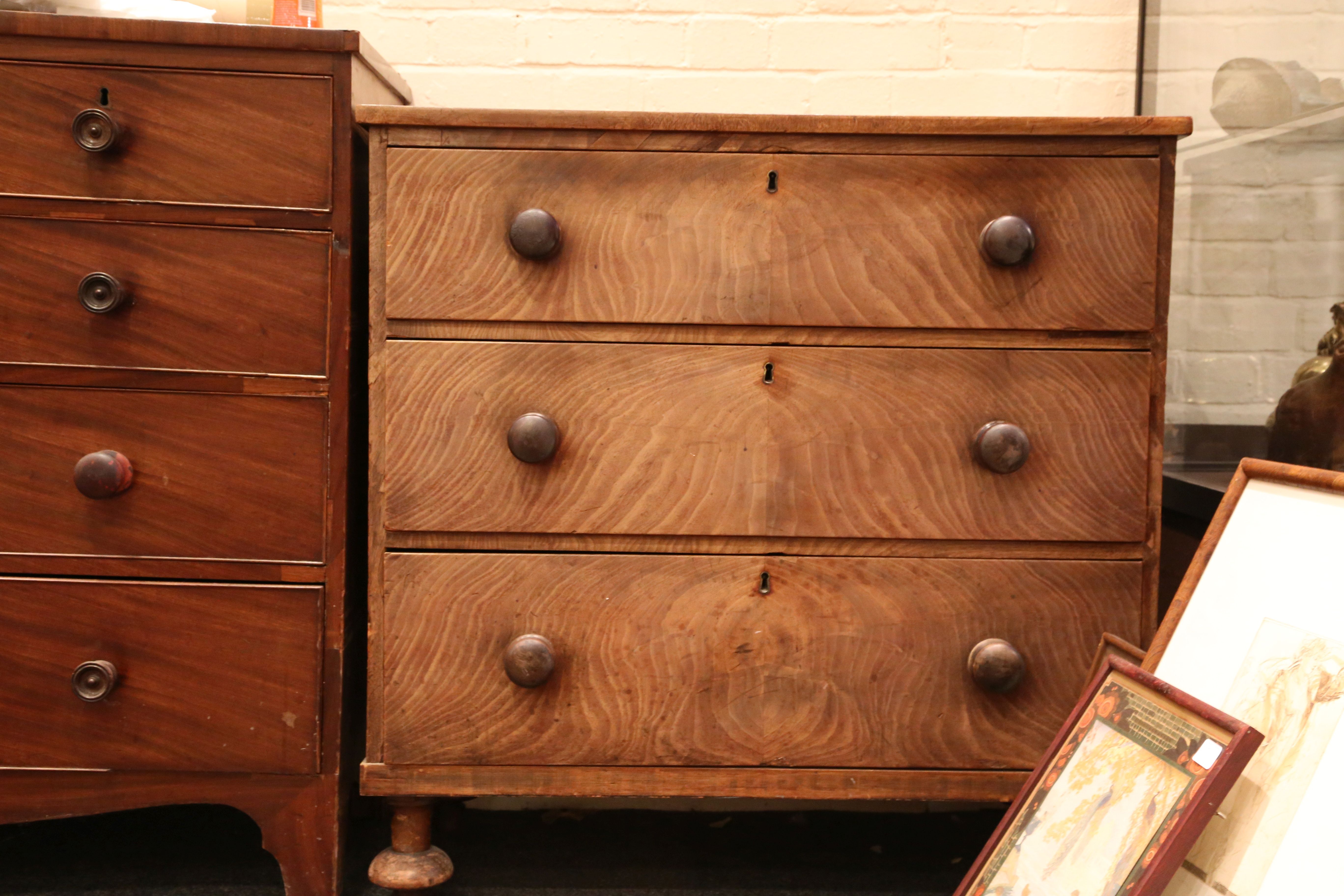 A Victorian mahogany chest of three long drawers, on bun feet.