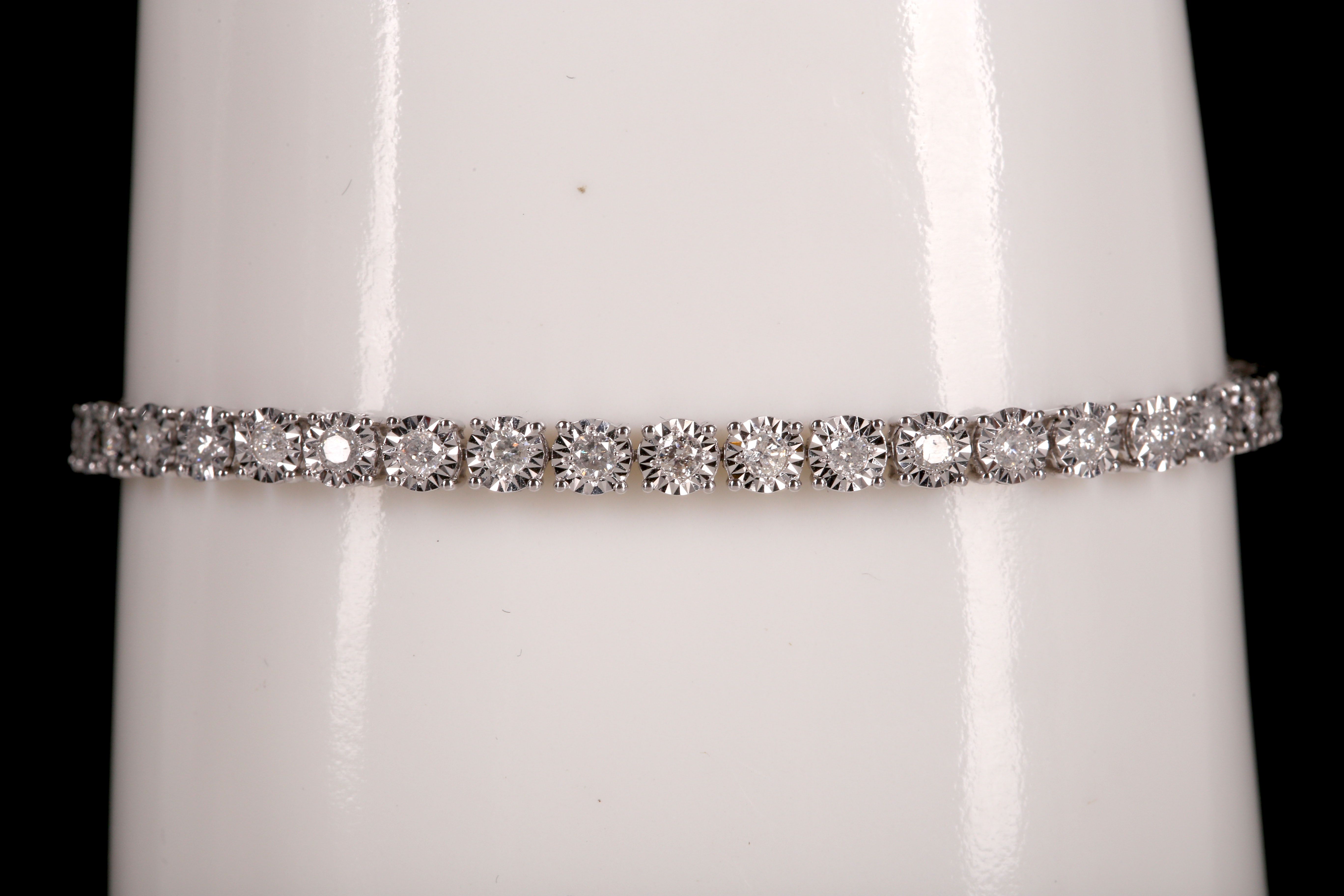 An 18ct white gold and diamond tennis bracelet, 2ct total.