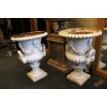 A pair of antique cast iron twin handles Campana urn form jardinières, having floral garland