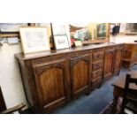 A large 19th Century French oak dresser base, with central drawers flanked by four cupboards,