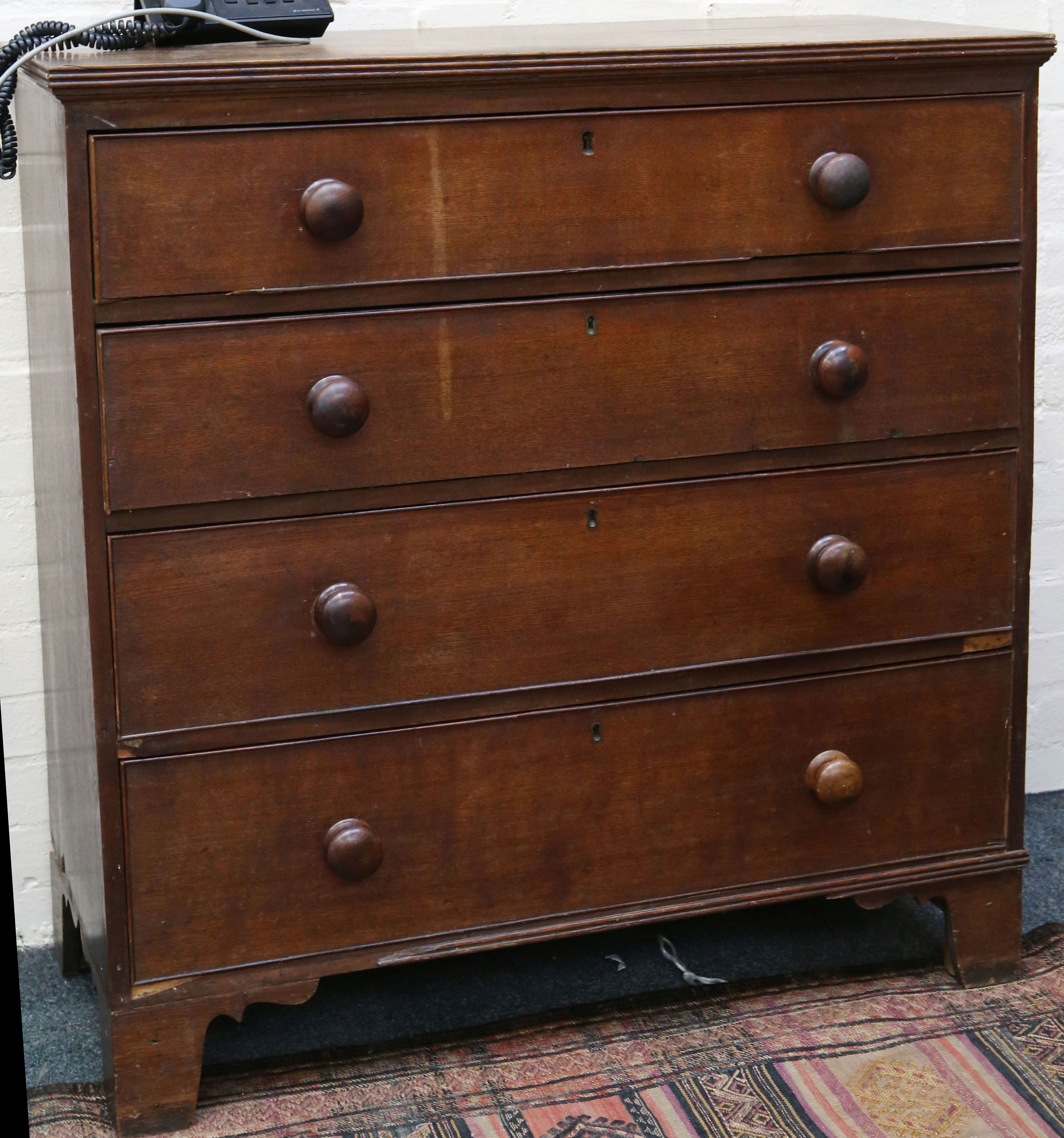 A 19th Century oak chest of drawers, bun handles, four graduating drawers with beading, bracket
