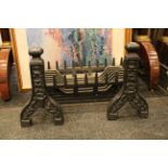 A pair of antique cast iron fire dogs, contemporary supports and basket, basket 59.5cm W.