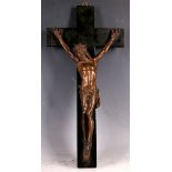 A late 19th Century bronze crucifix, the bronze corpus on an ebonised fruit wood cross, 40 x 20cm.