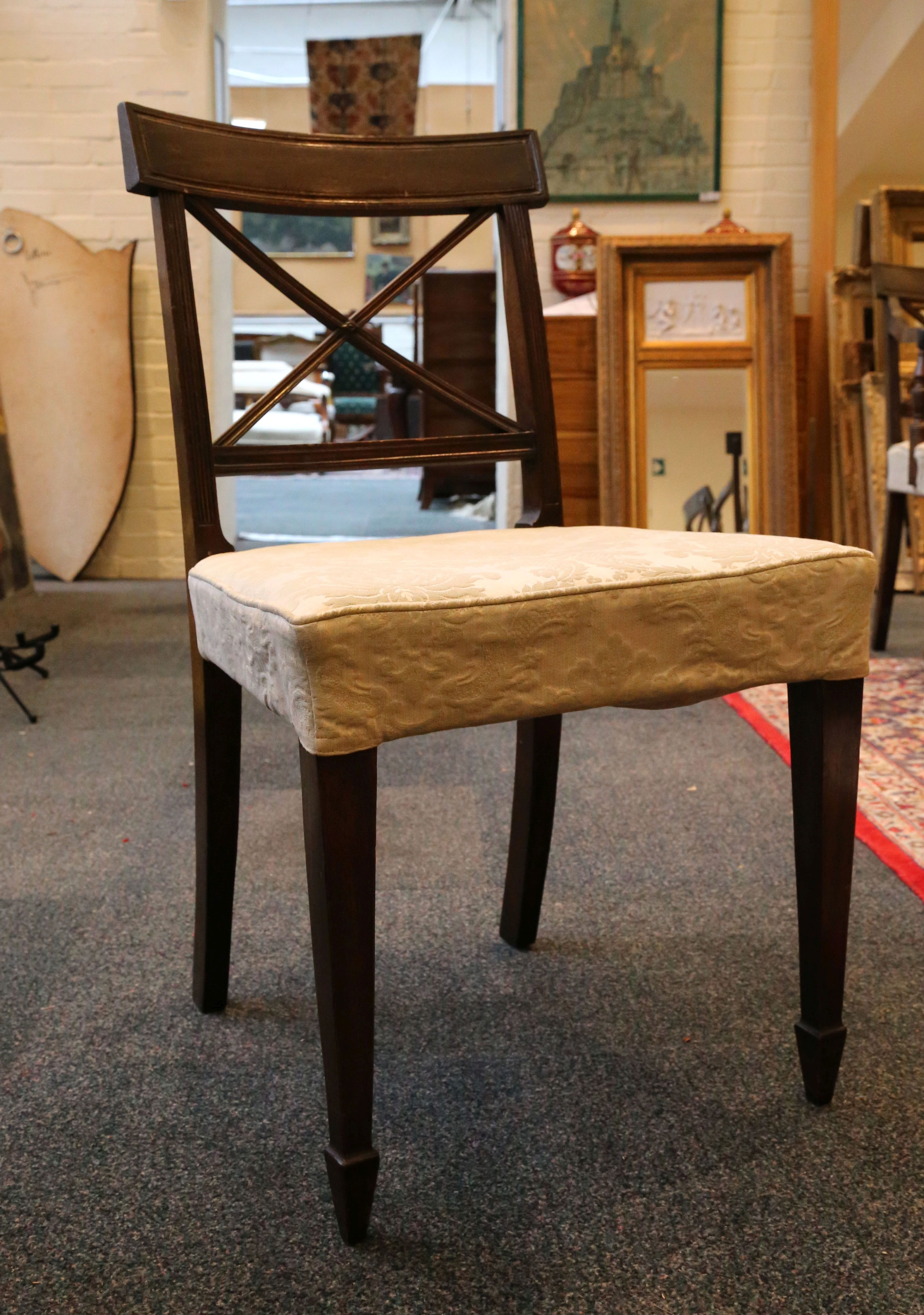 A set of seven Edwardian mahogany dining chairs, curved back 'X' form struts, supported on