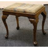 A walnut Queen Anne Revival stool, with needlework drop-in seat, raised on scrolling cabriole legs