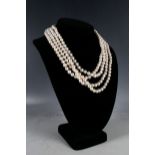 A four strand rose pearl necklace, together with another necklace with black pearls. (2)