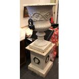 A large Campana twin-handled cast iron urn jardinière, with foliate scrolling to body, with socle