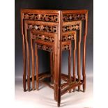 A nest of four Chinese hardwood tables, having carved aprons and inset tops. (4)