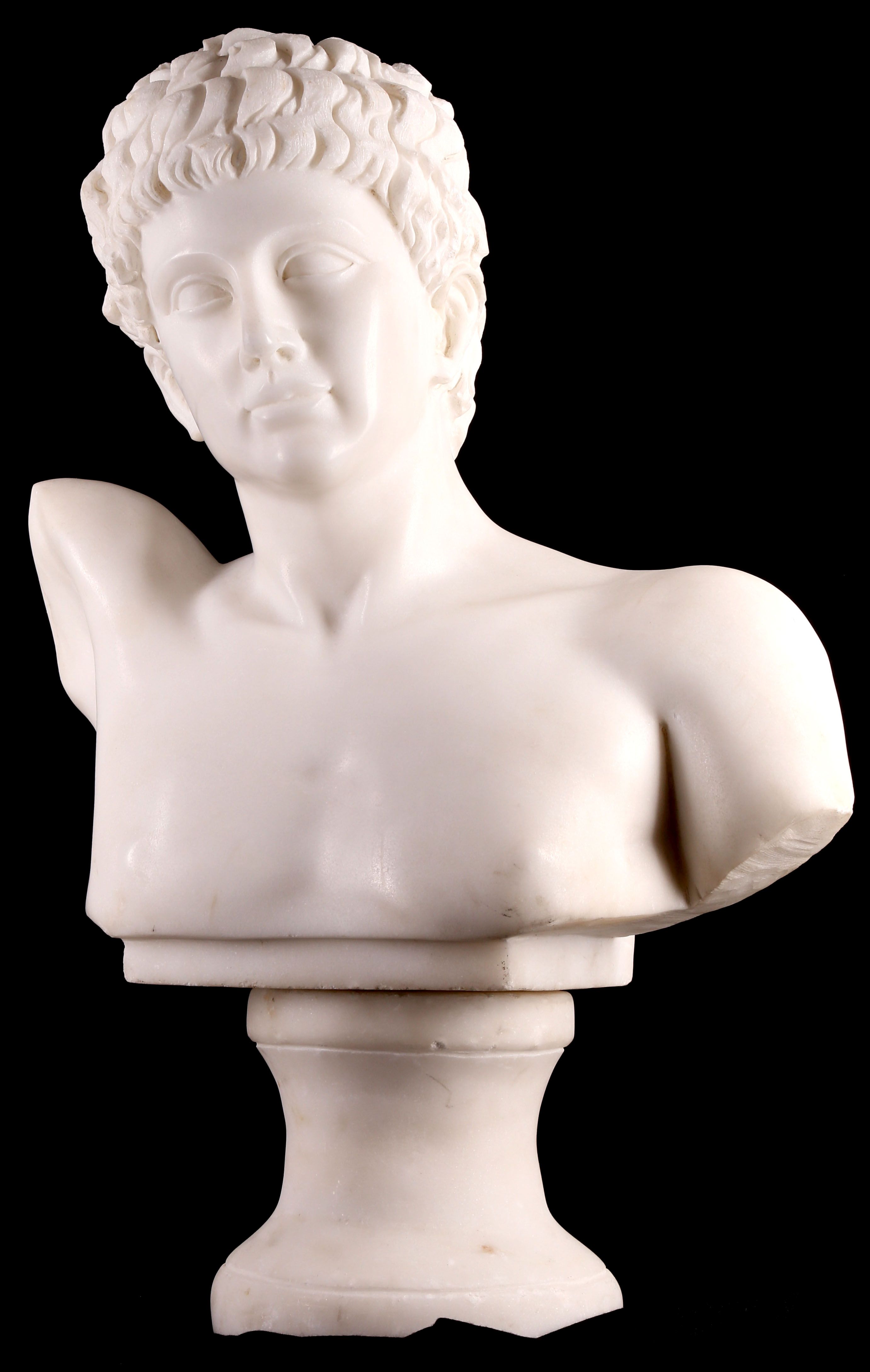 A white marble bust of Adonis, after the Antique, on a socle, 62cm H approx. (on socle).