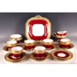 An Aynsley bone china twenty-piece tea service, having inner red band within gold floral border. Set