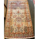 A Persian Ghome silk rug, floral running borders, urn with floral bouquet, 155 x 91cm.