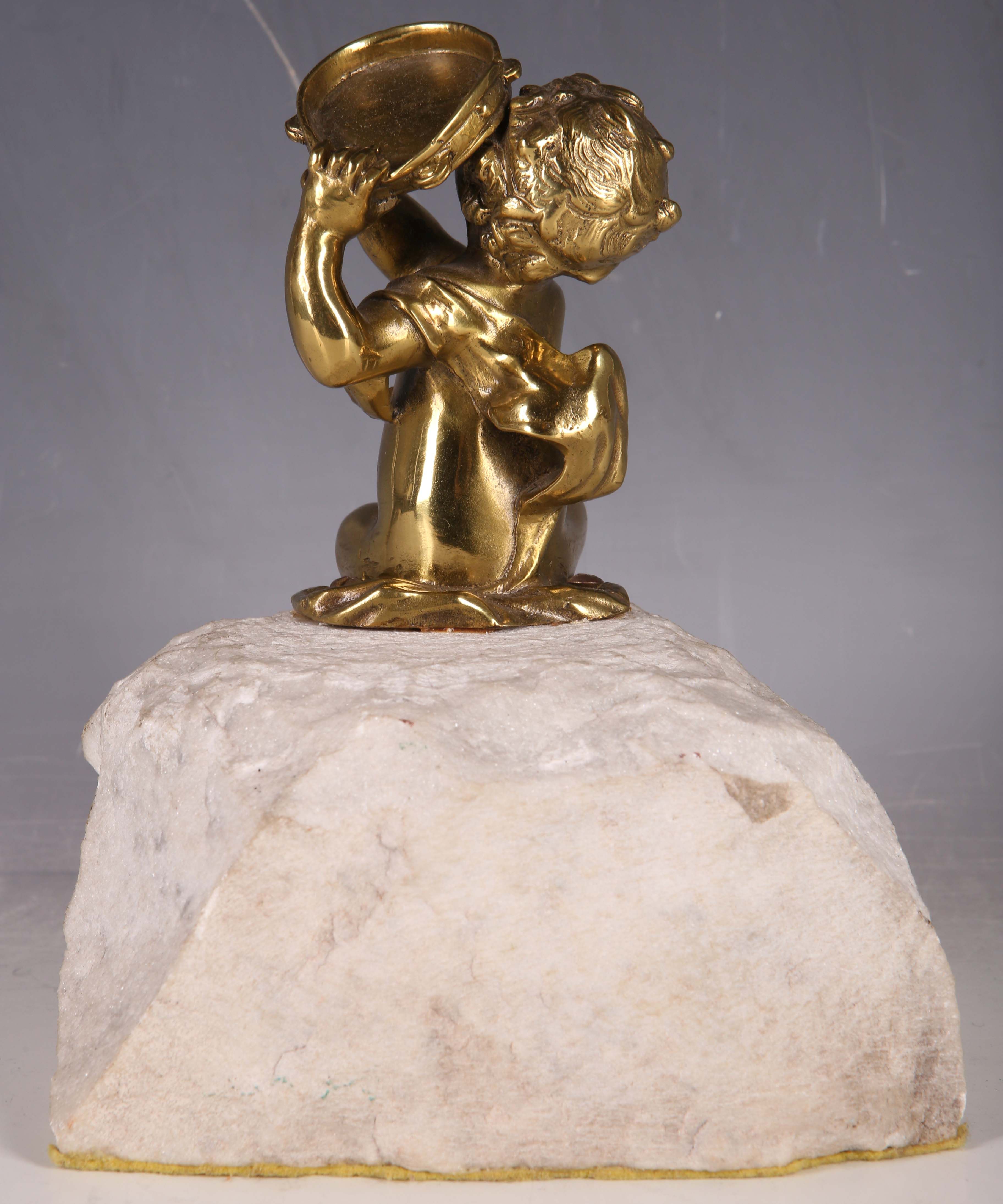 A late 19th Century solid brass statue of a child with tambourine, raised on a rough hewn quartz - Image 2 of 2