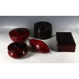 A selection of three wooden and two leather boxes and covers, three with red 'ochre' finish. (5)