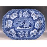 An early 19th Century pearlware blue and white platter, with all over transfer pattern (AF, hair